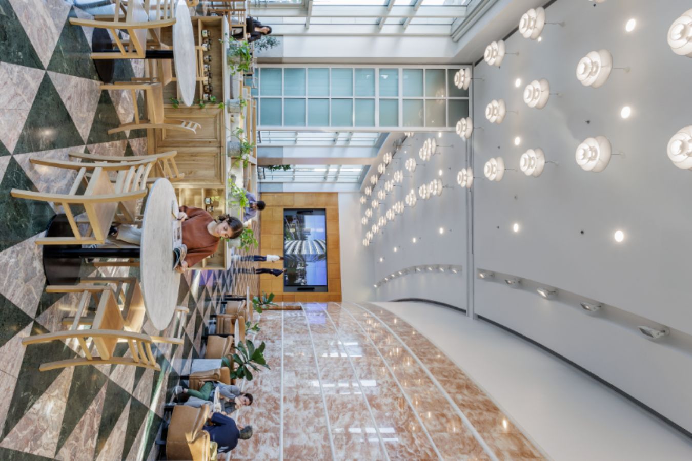 Edificio Republica - Double-height corporate lobby with geometric terrazzo flooring and globe pendant lighting - Contract Workplaces.jpg
